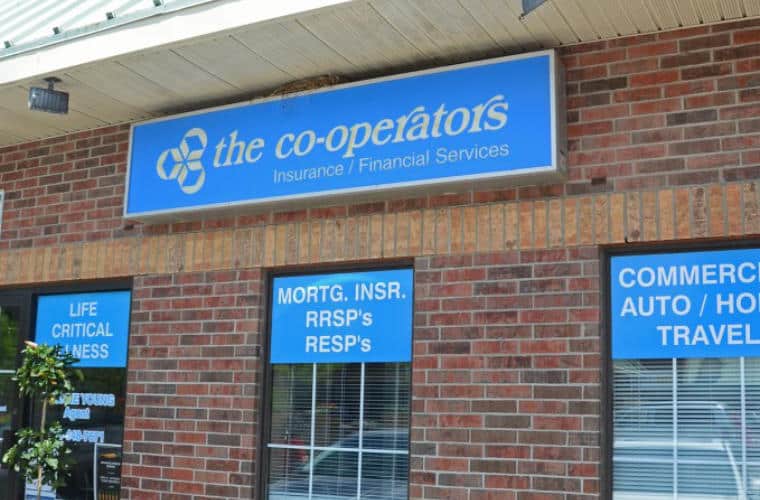 A red brick building with a sign for The Co-Operators Insurance above the windows.