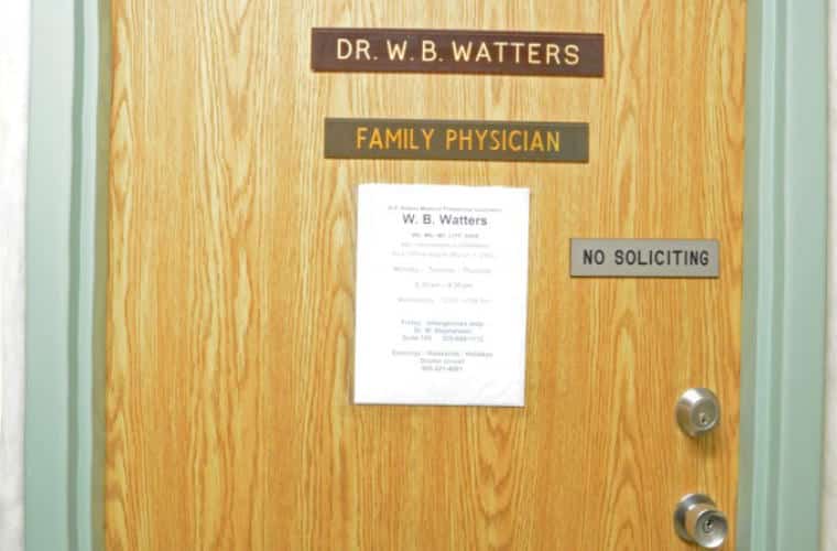 A wooden door with a plaque for DR. W. B. Watters Family Physician on it.