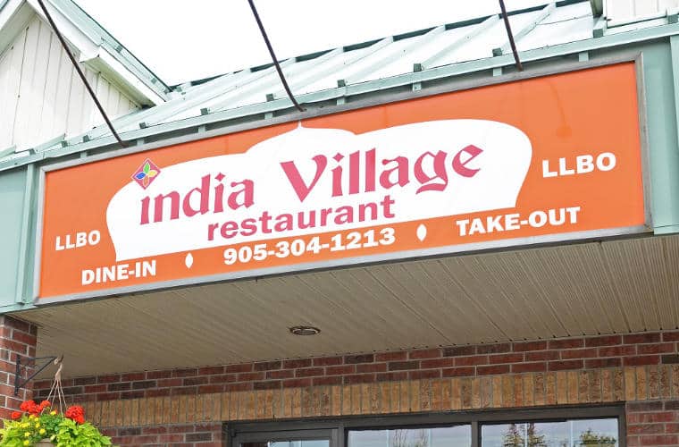 The sign for India Village Restaurant above its entrance.